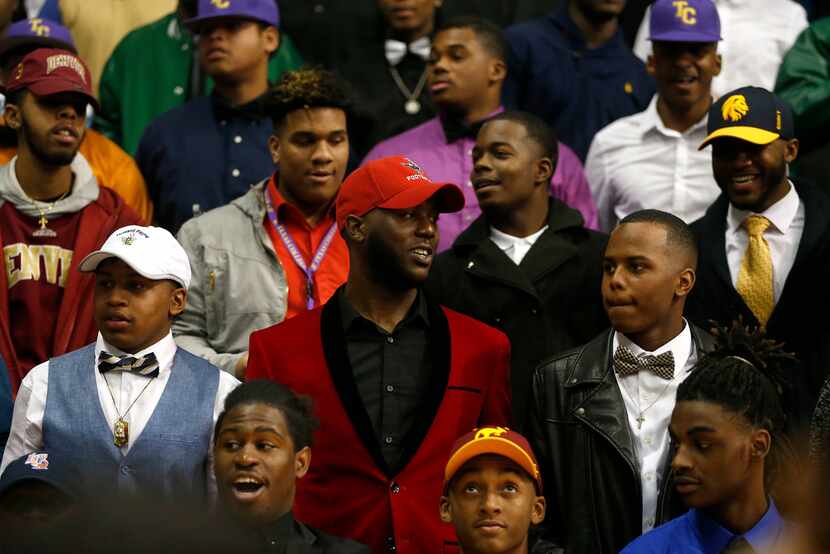 DISD athletes pose for a group photograph during the national signing day ceremony at Ellis...