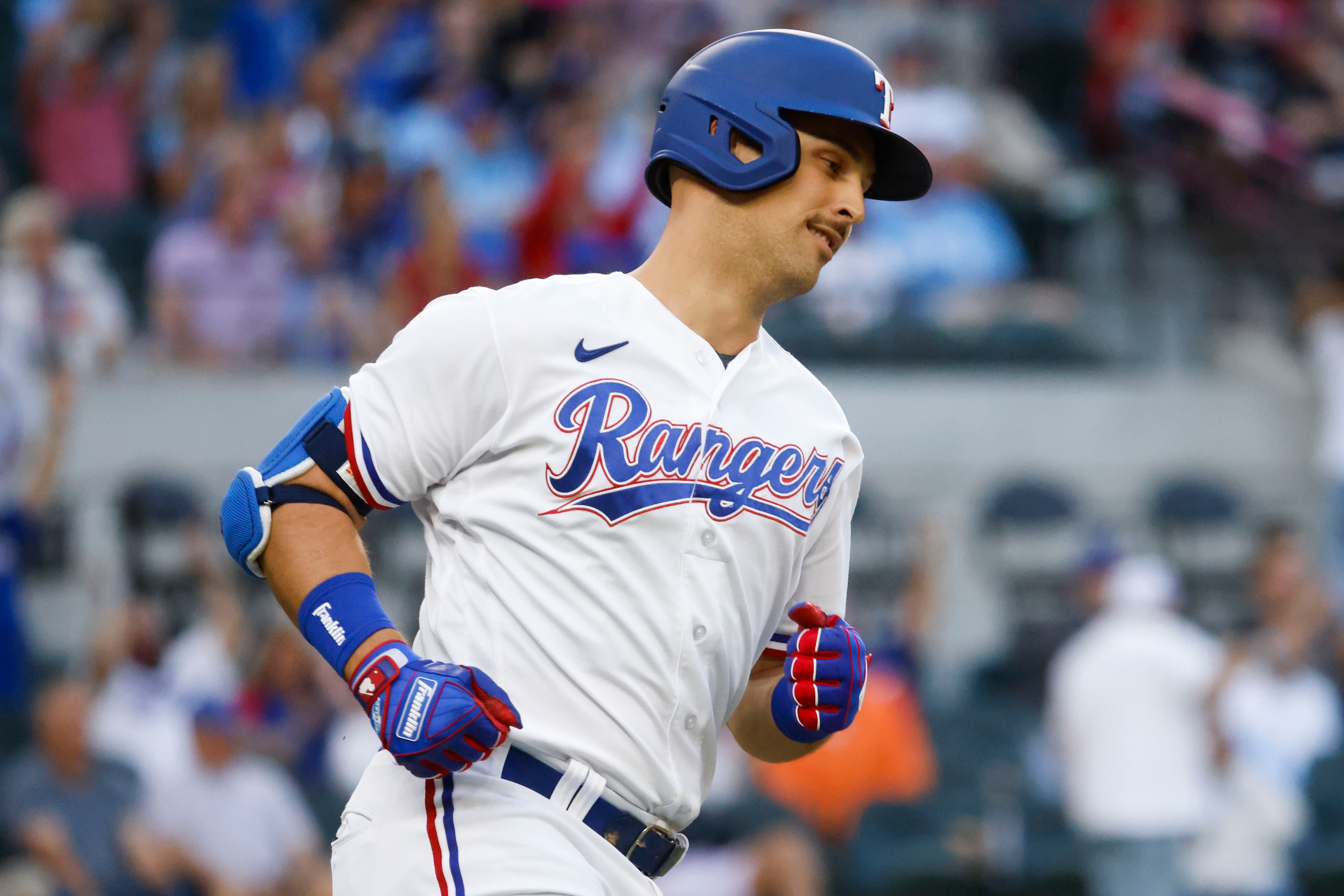 Texas Rangers first baseman Nathaniel Lowe reacts after hitting a home run on a fly ball...