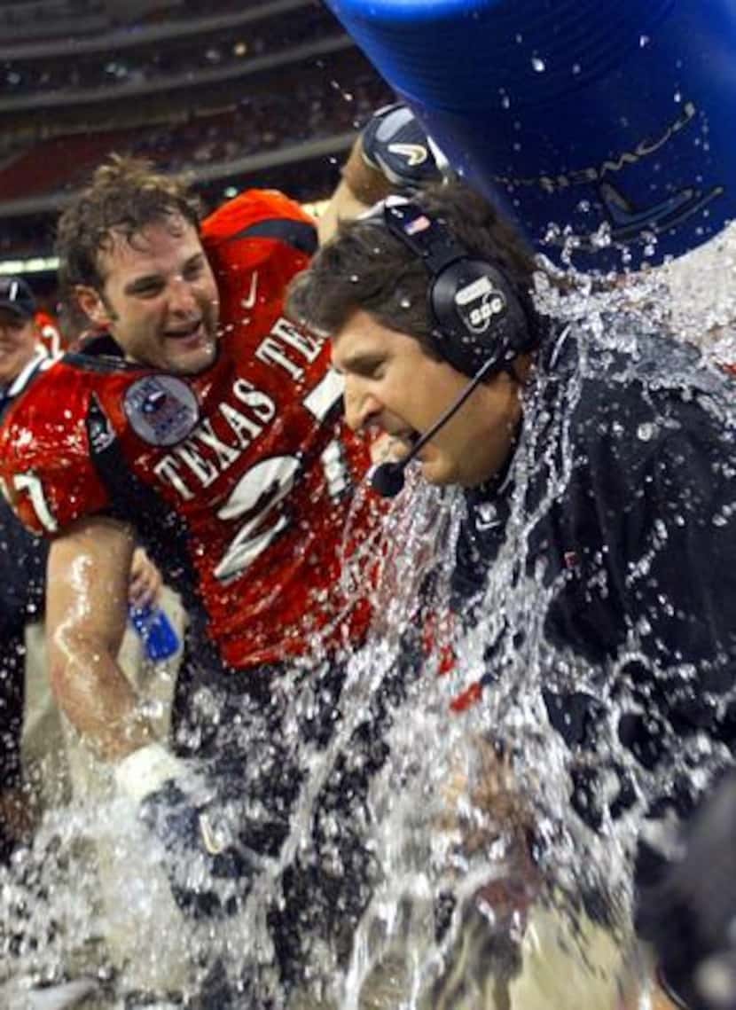 Dec. 30, 2003: Texas Tech's Wes Welker (left) helps dump water on Mike Leach with seconds...