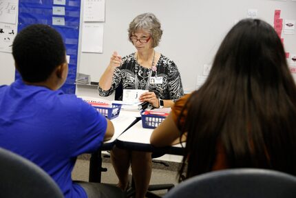 Ivonne Tennent shows Benjamin Hutchinson (left) and Madalyn Harrison flash cards in the...