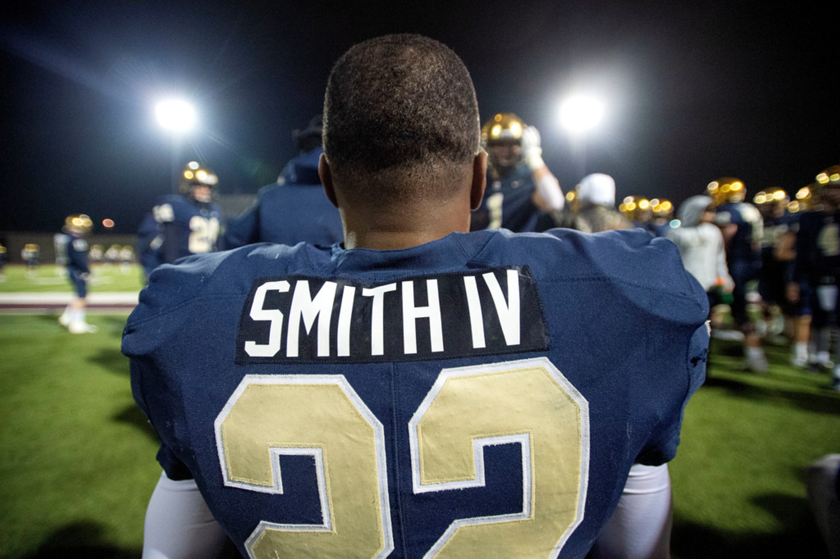 Jesuit senior running back E.J. Smith (22) sits on the bench after scoring a touchdown on...