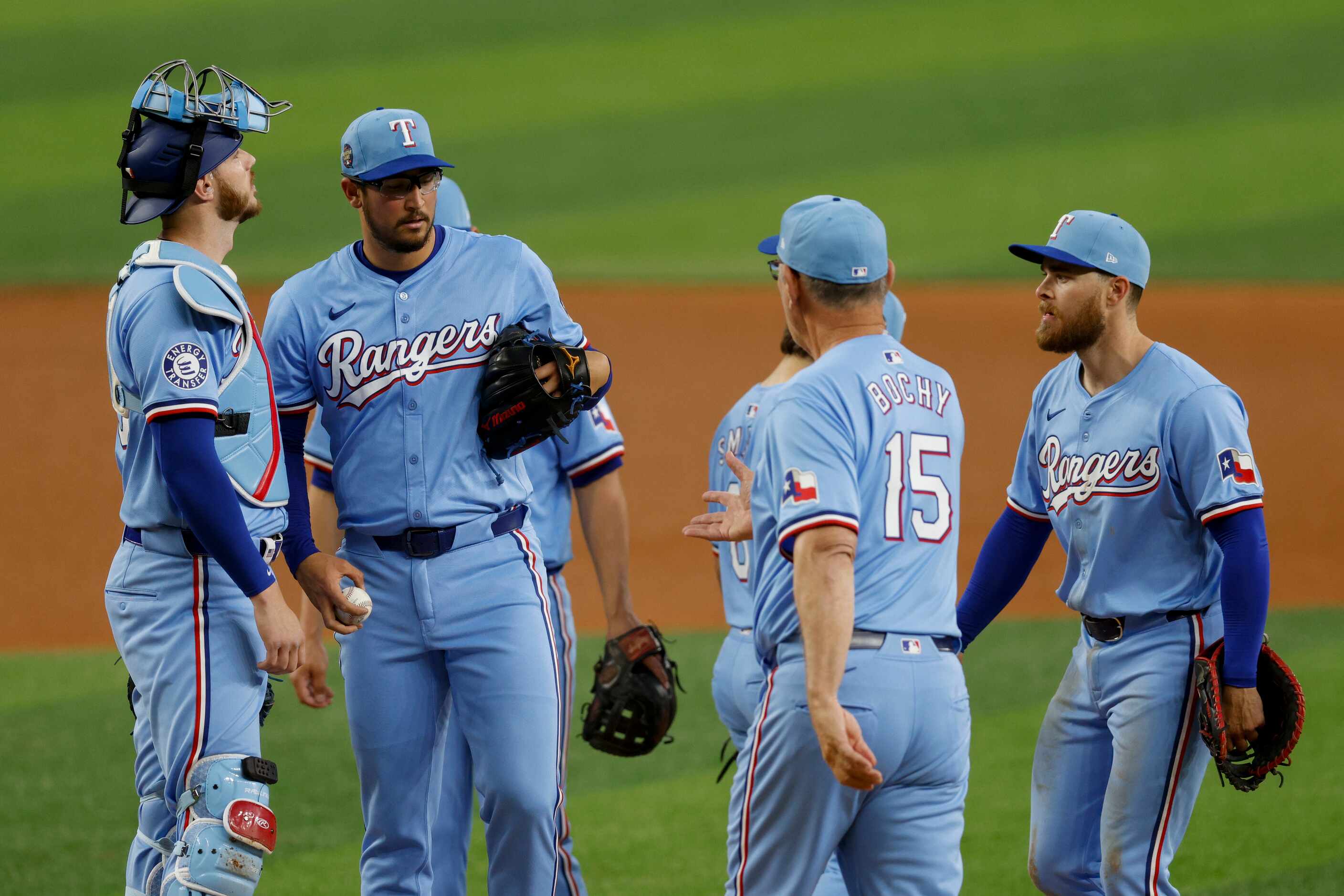 Texas Rangers manager Bruce Bochy (15) takes the ball from pitcher Dane Dunning (33) as he’s...