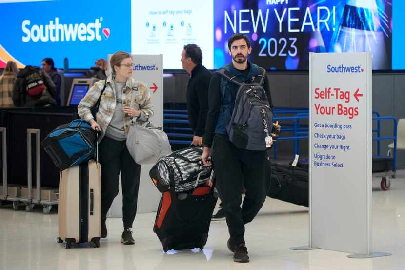 Travelers head to Southwest Airlines check-in counters at Denver International Airport on...