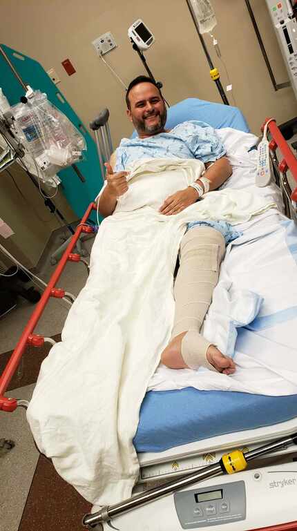 Dr. Carlos Chapa gives a thumbs-up from a hospital bed after he was wounded Sunday, Feb. 9,...