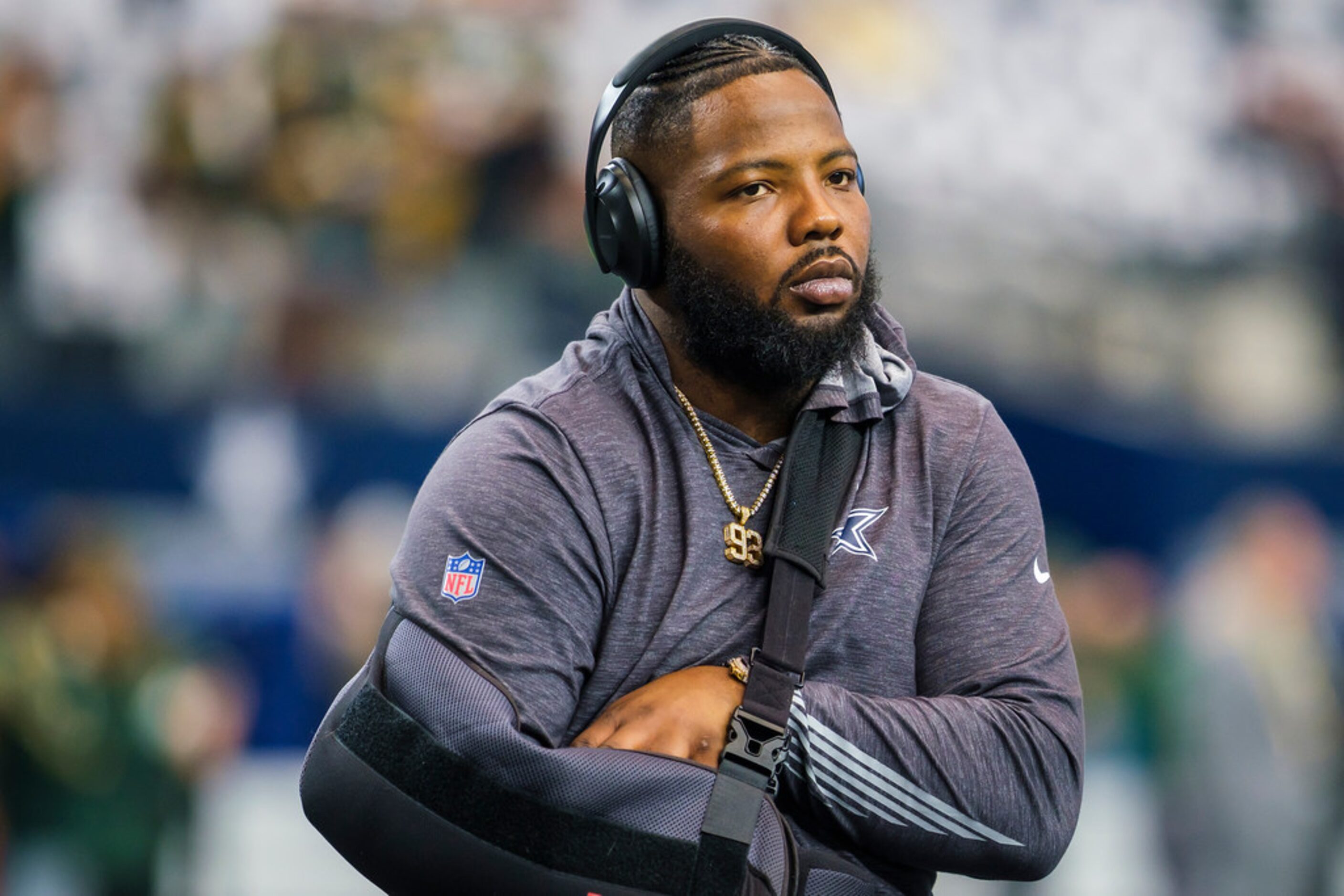 Dallas Cowboys defensive tackle Daniel Ross watches teammates warmup before an NFL football...