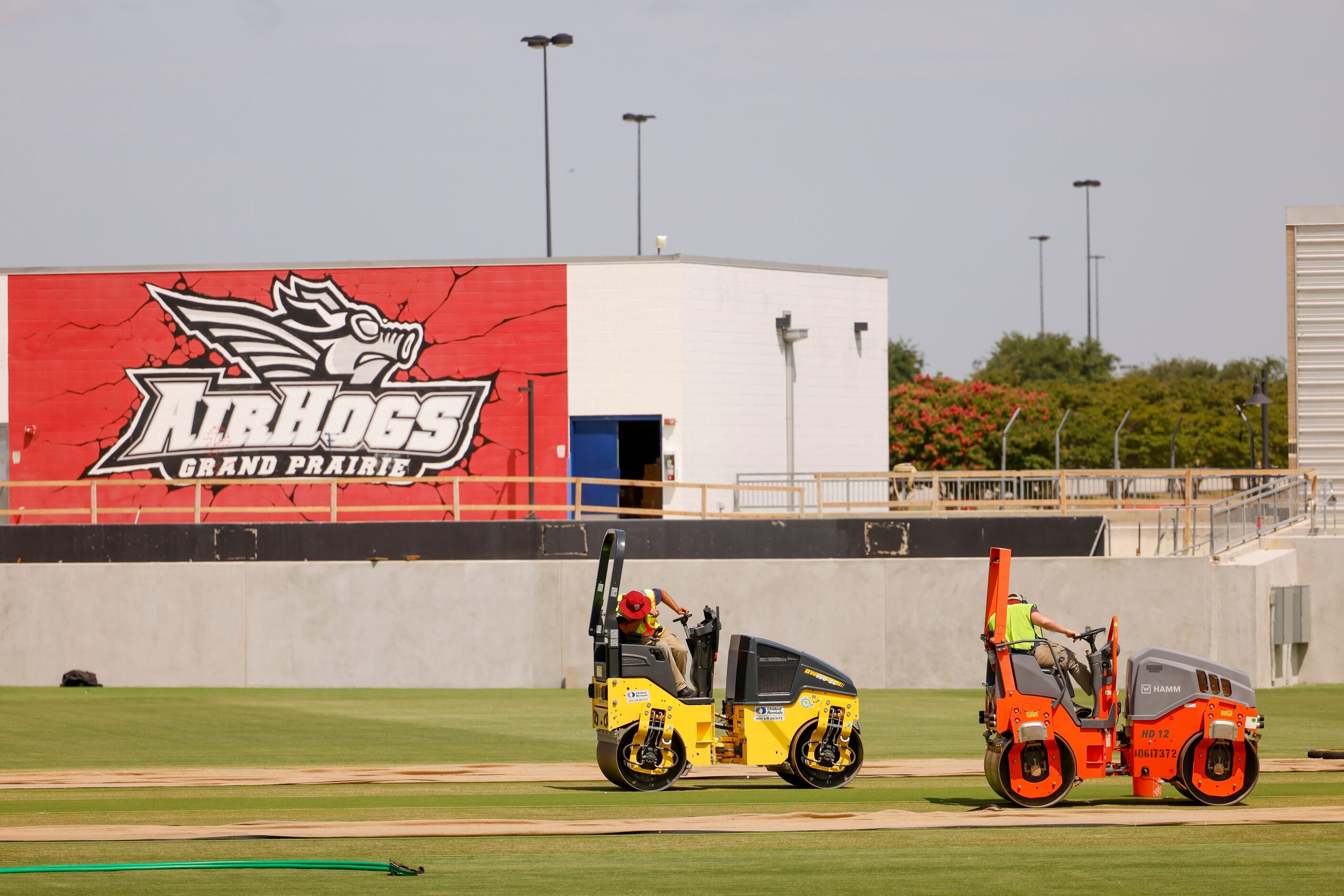 Groundsmen curate a cricket pitch on Thursday, July 6, 2023, at Grand Prairie Stadium, ahead...