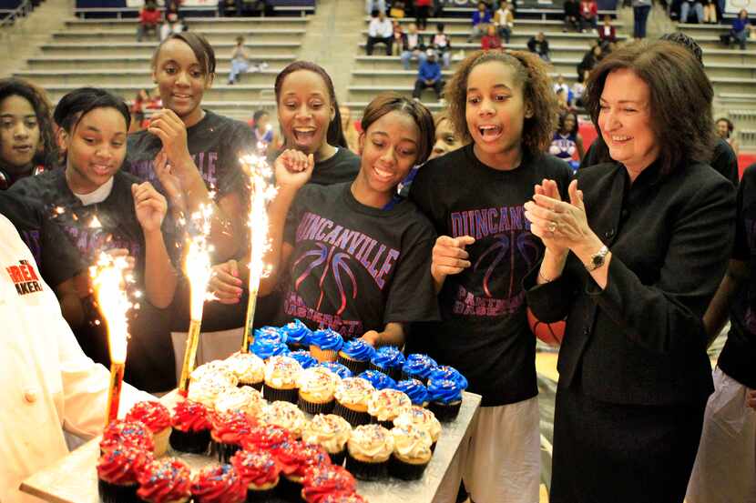 Duncanville girls basketball coach Cathy Self- Morgan celebrates with her players and is...