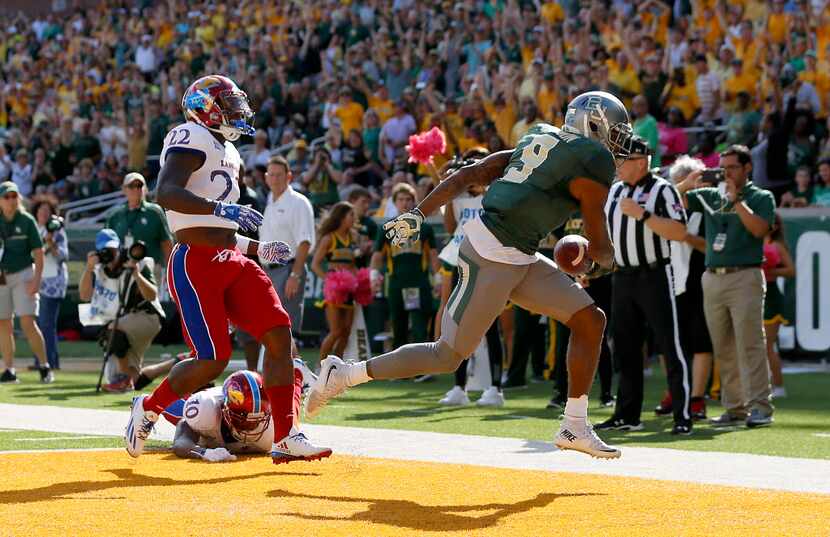 Baylor wide receiver KD Cannon (9) scores a touchdown past Kansas safety Greg Allen (22) and...
