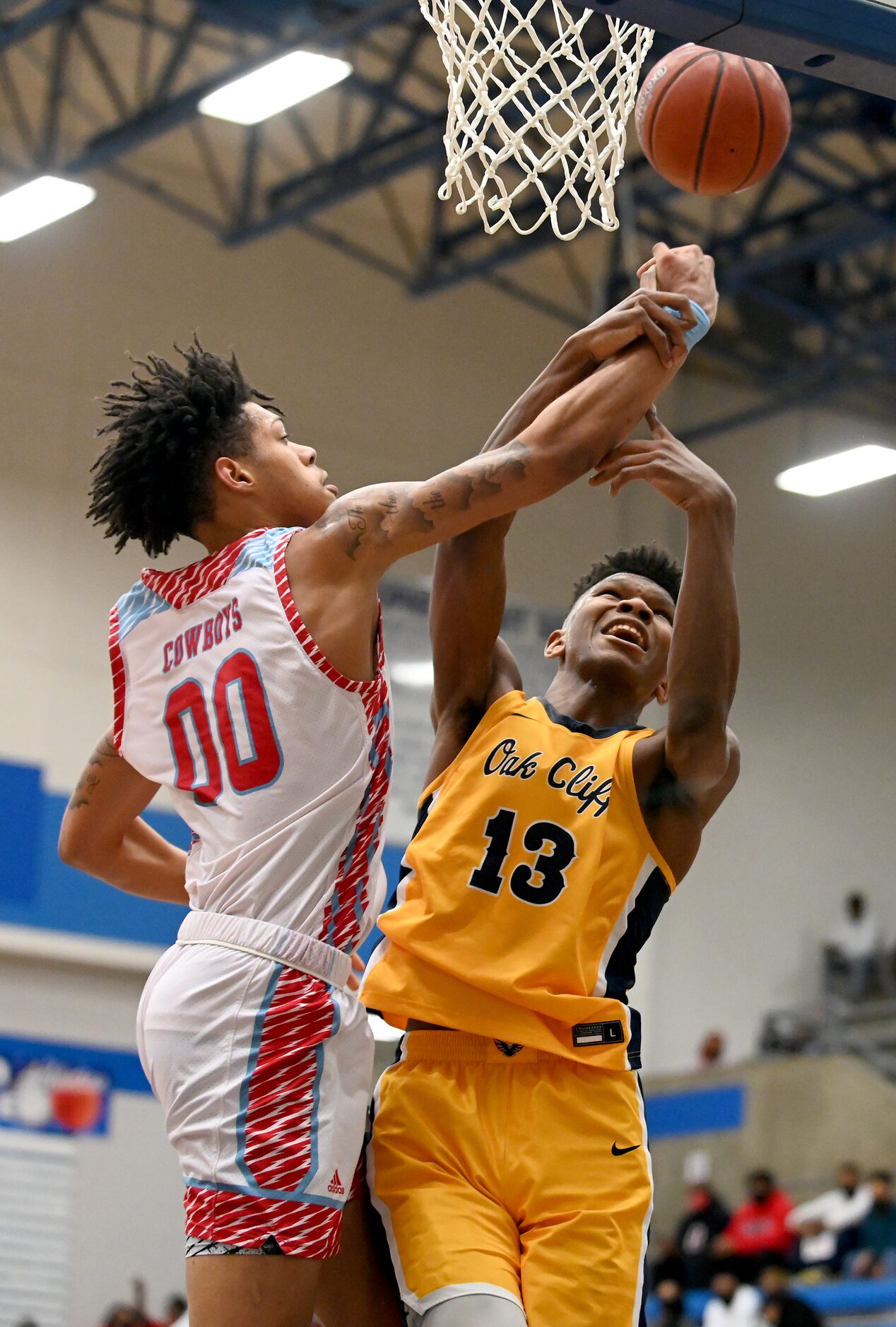 Faith Family’s Mekhi Collins (13) goes up for a shot on Carter’s Addarin Scott (00) in the...