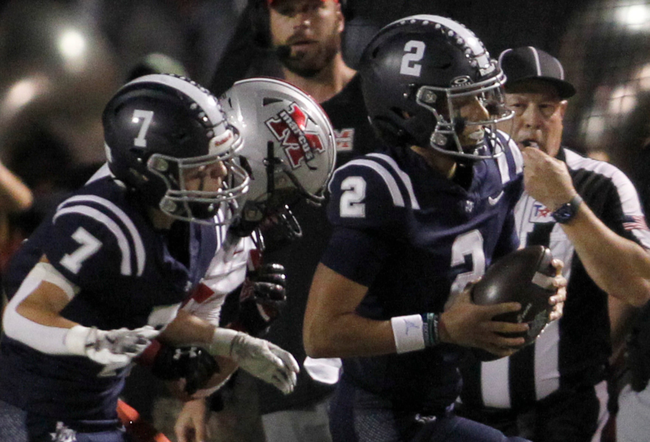 Flower Mound quarterback Noah Spinks (2), right, rushes for a first down during first half...