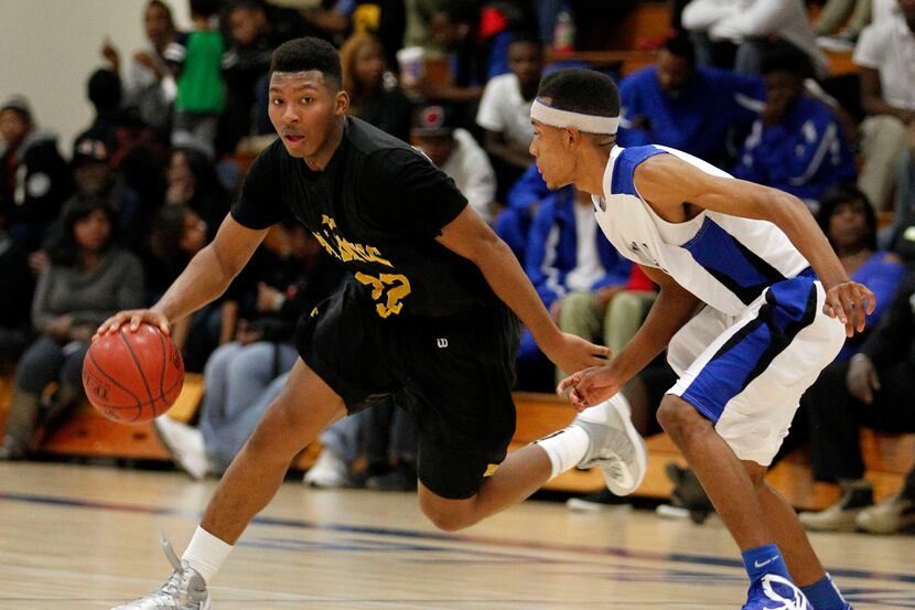 Triple A Academy's King McClure (22) attempts to drive past Seagoville's Xavier Huey (2) at...