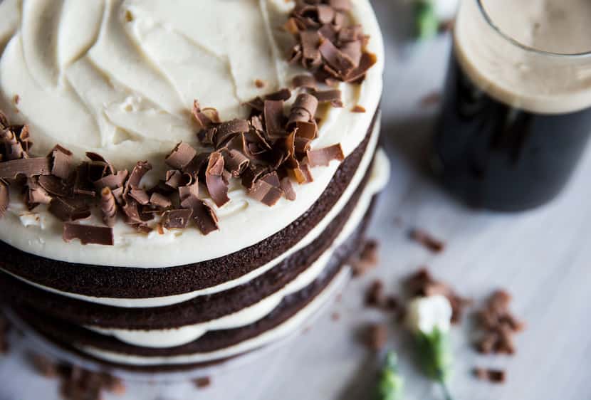 A Guinness cake with Irish cream cream cheese icing, paired with a glass of Guinness.