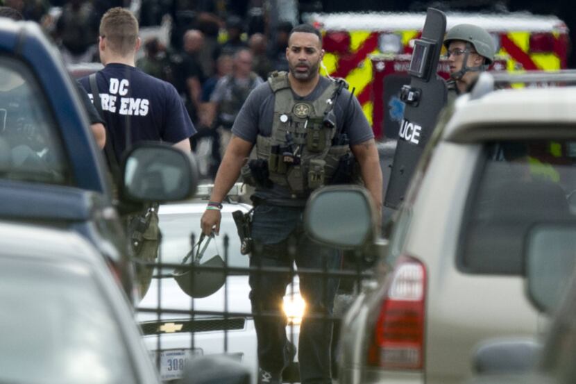 Police tactical units leave after responding to a shooting at the Navy Yard in Washington,...