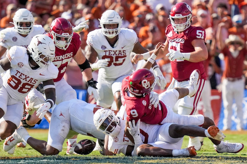 Oklahoma quarterback Michael Hawkins Jr. (9) fumbles as he is brought down by Texas...