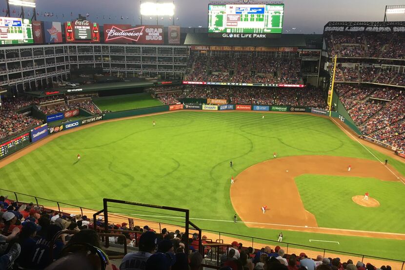 Outlines where the Rangers grounds crew had to resod before the season are obvious during a...