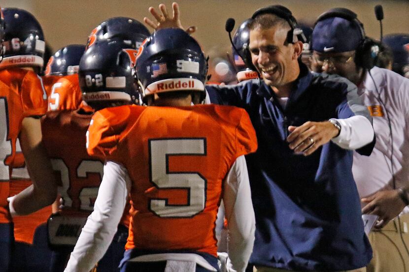Brandeis head coach Jeff Fleener congratulates his player after a score during the  District...