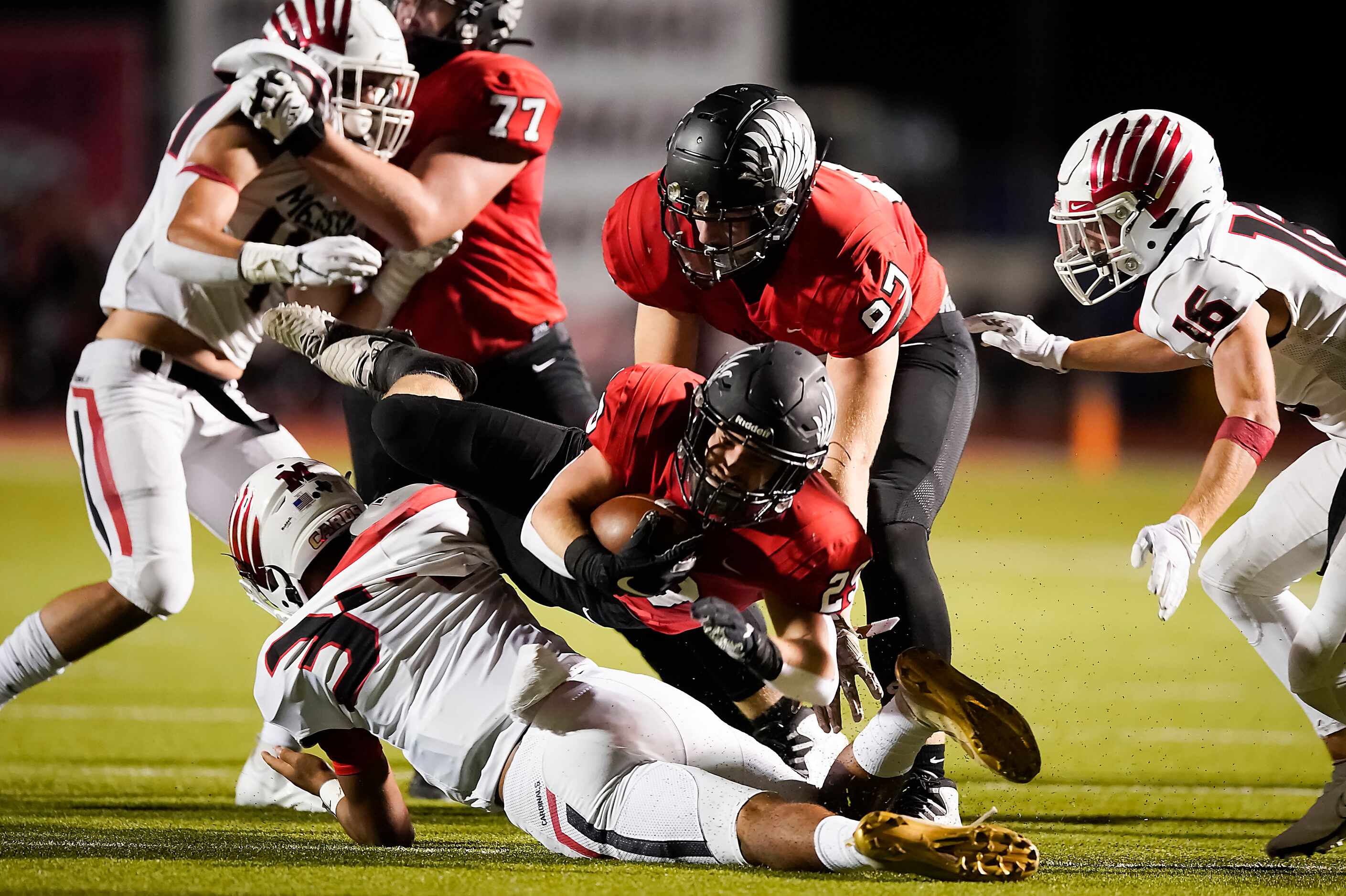 Argyle running back Braden Baker (29) is knocked off his feat by Melissa linebacker Caleb...