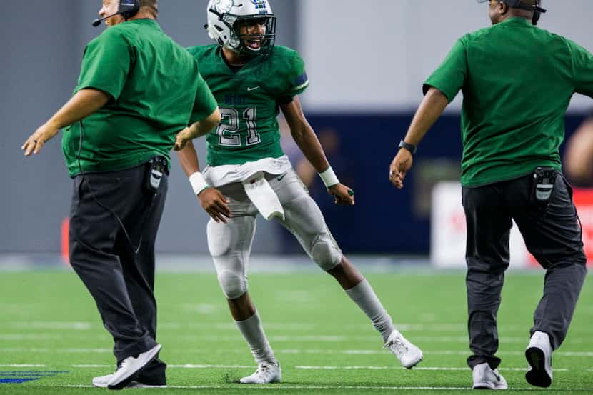 Frisco Reedy defensive back Dominic McCorry (21) celebrates with coaches after he caught an...