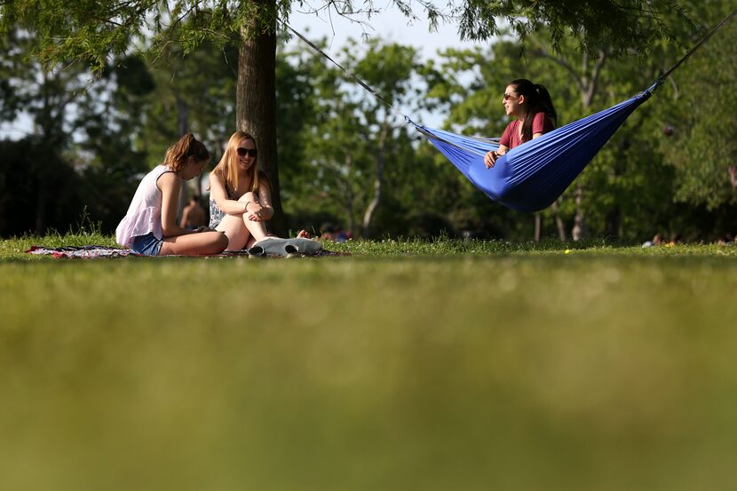 Friends (from left) Schuler Ravencraft, Tess Martin and Haley Ginsberg relax as the sun sets...