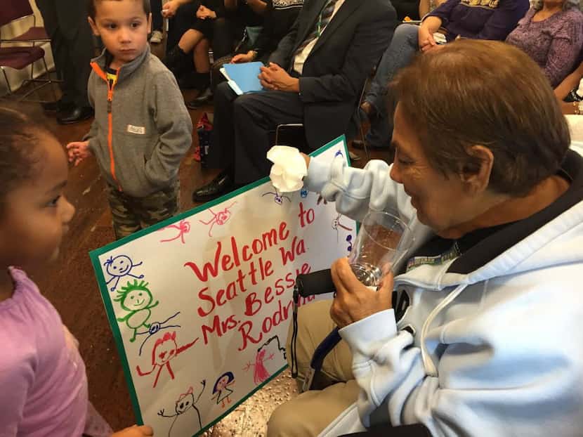 Children at Centro de la Raza in Seattle greet Bessie Rodriguez of Dallas during her visit...