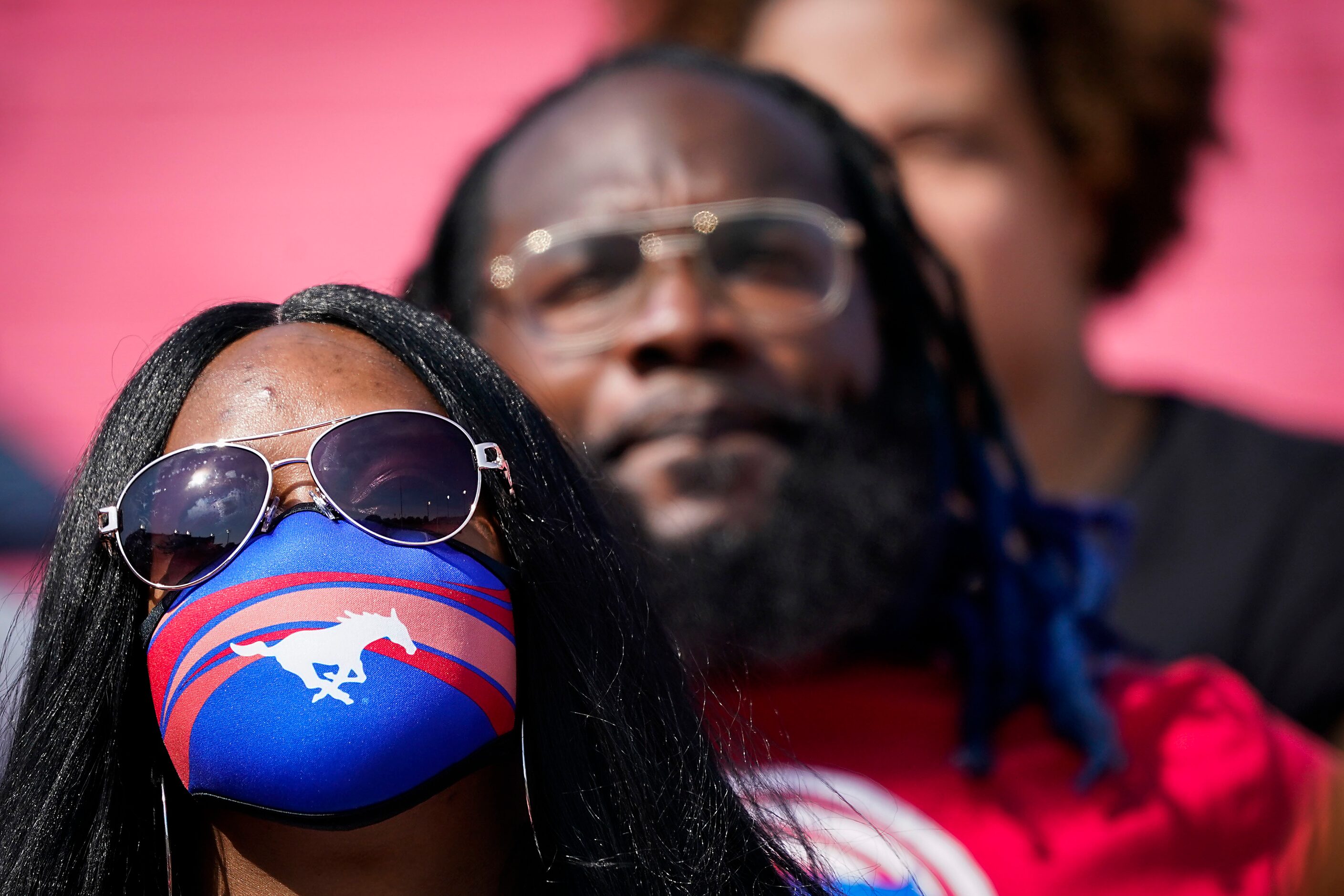 SMU fans sit socially-distanced in the stands during the first half of an NCAA football game...