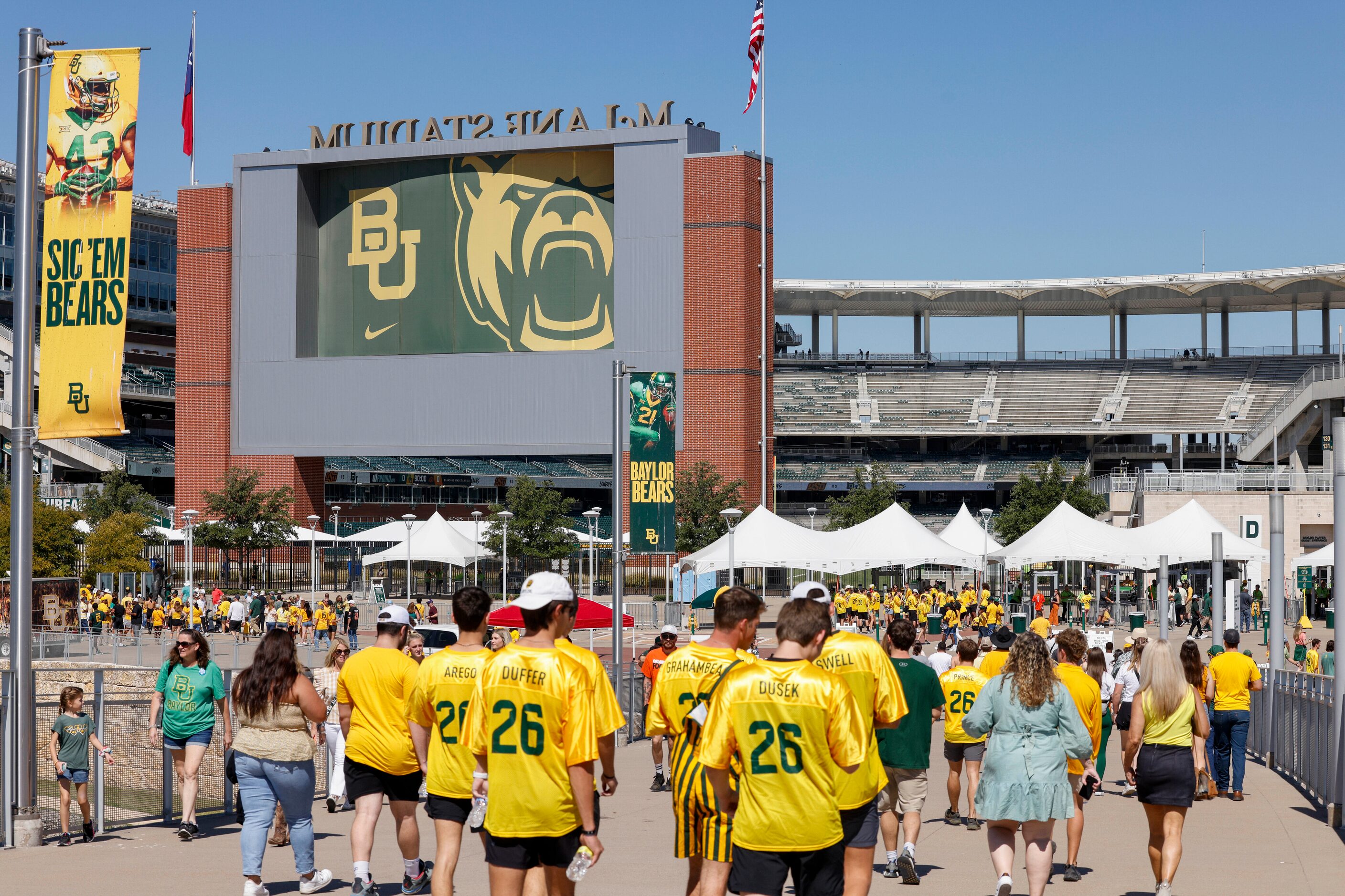 Fans cross over the Brazos River before an NCAA football game between Baylor University and...