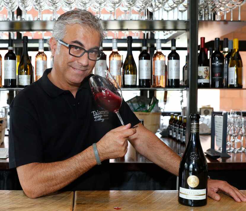 Daniele Puleo, chef-owner of CiboDivino Marketplace in Dallas, swirls a glass of Lambrusco.