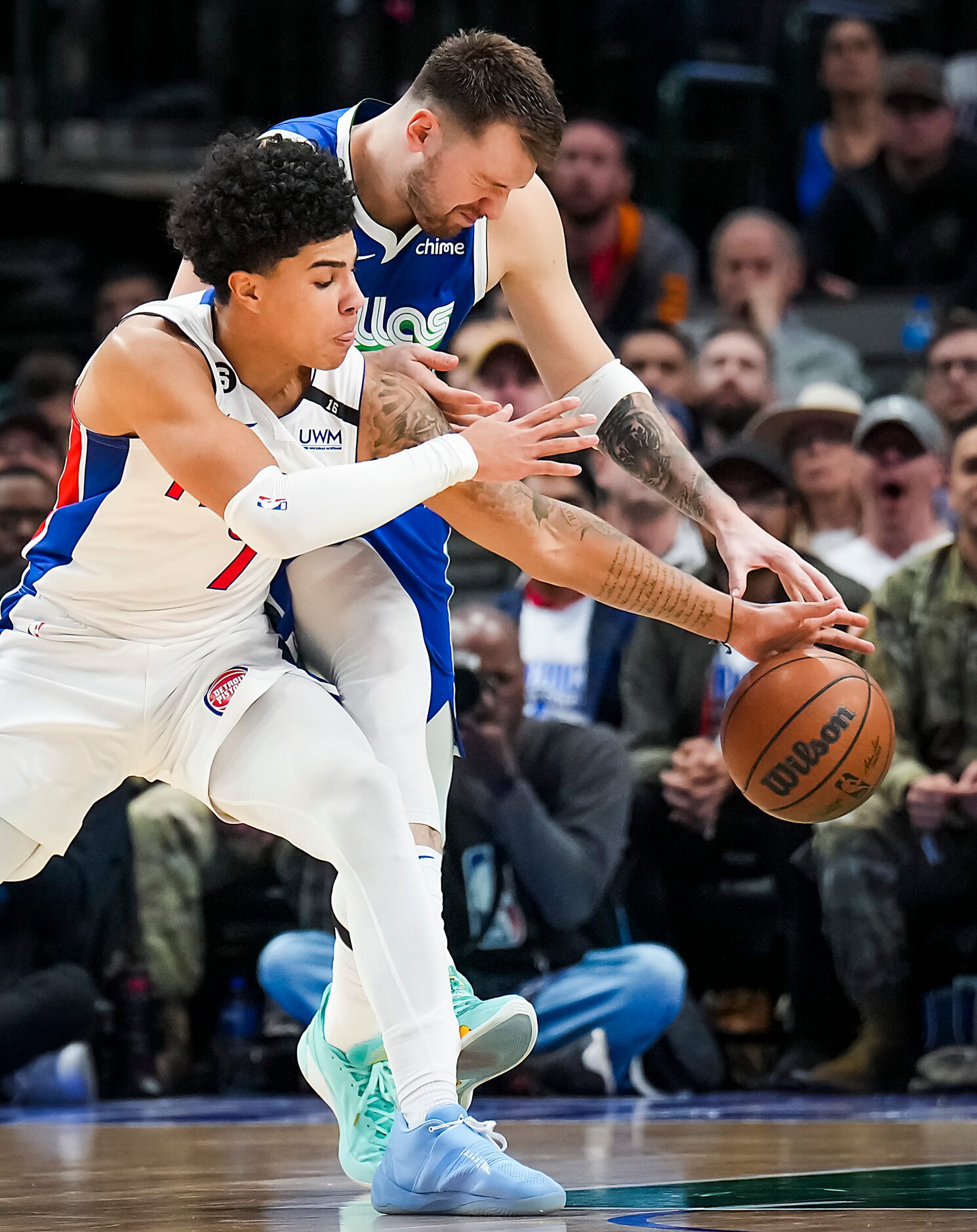 Dallas Mavericks guard Luka Doncic (77) fights for a loose ball against Detroit Pistons...