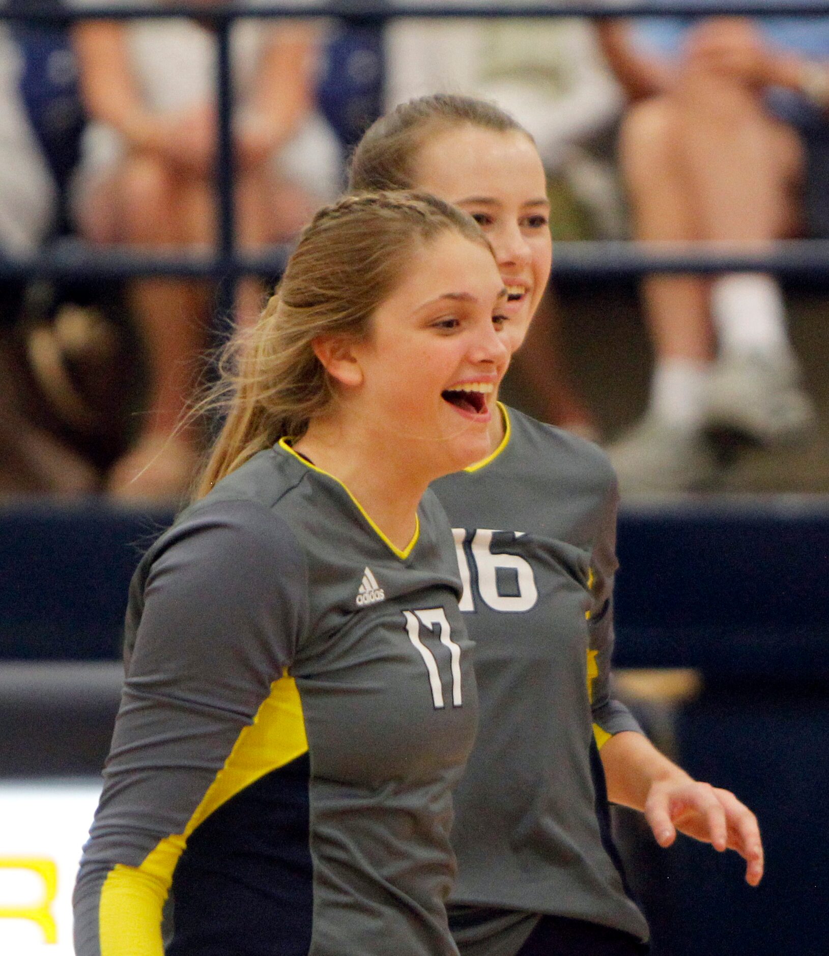 Highland Park middle hitters Alex Richter (17), front, and Nicole Mauser (16) celebrate a...