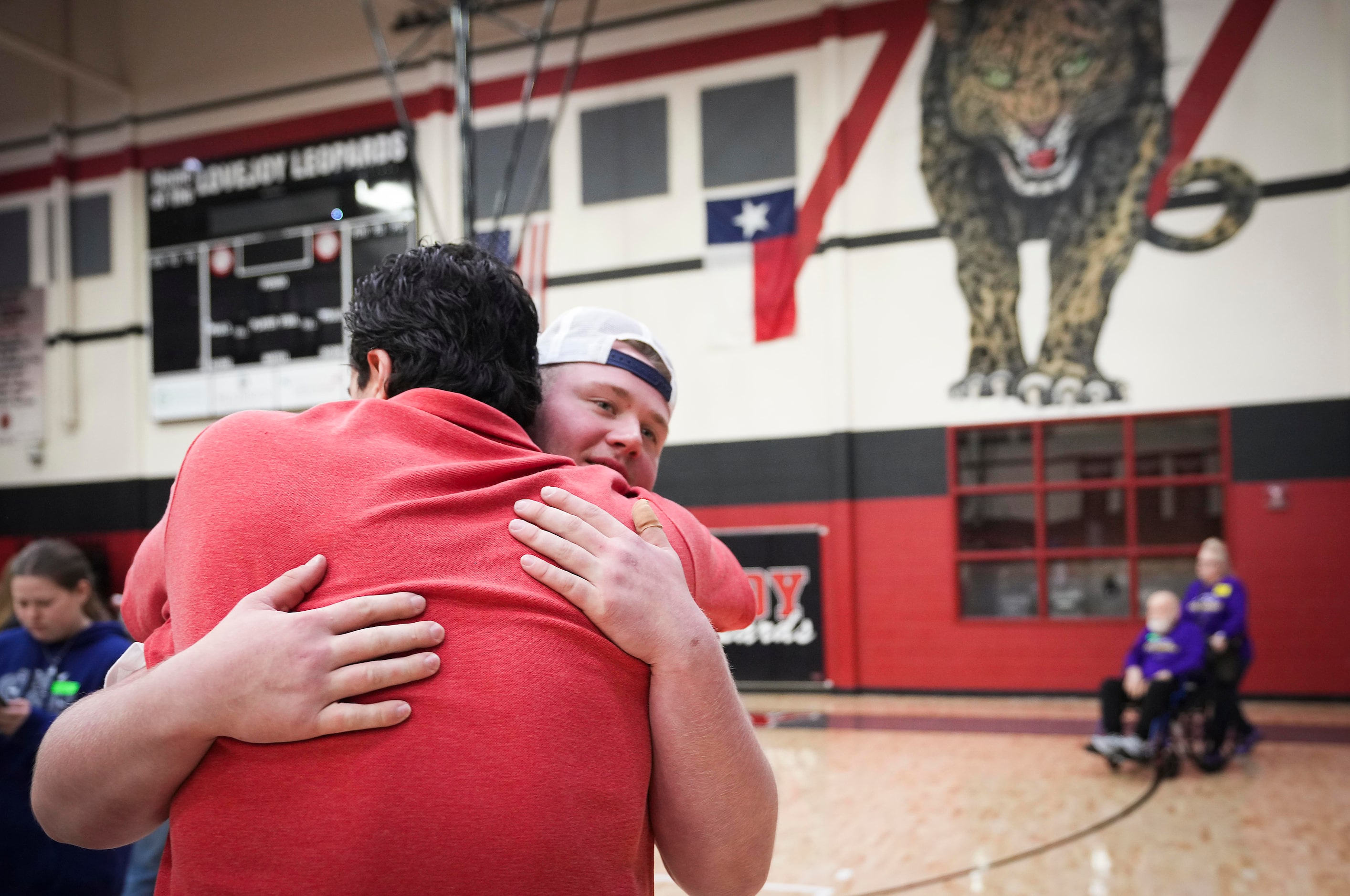 Lovejoy all-state offensive lineman Sam Reynolds is congratulated by a coach during a...