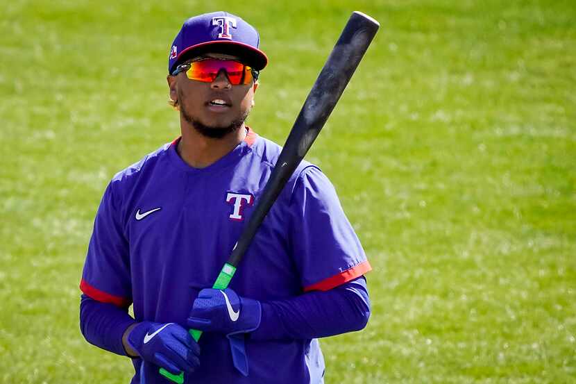 Texas Rangers outfielder Willie Calhoun prepares to take batting practice during a spring...