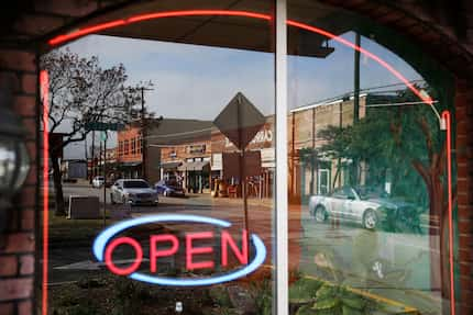 A view of the square in downtown Mesquite, Texas reflected in the window of Dos Panchas...