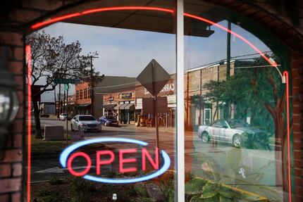 A view of the square in downtown Mesquite, Texas reflected in the window of Dos Panchas...