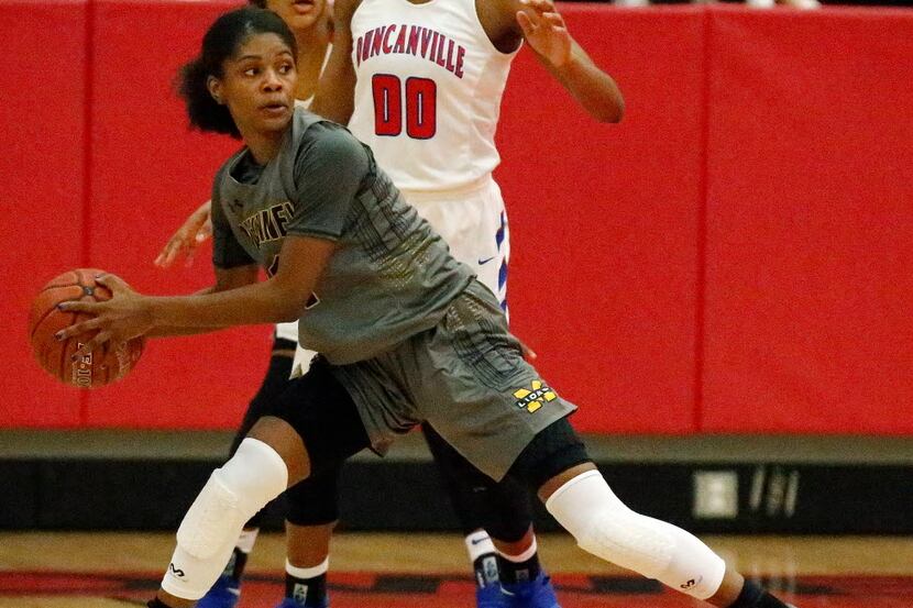McKinney forward Quincy Noble (11) attempts to keep her pivot foot in place while looking...