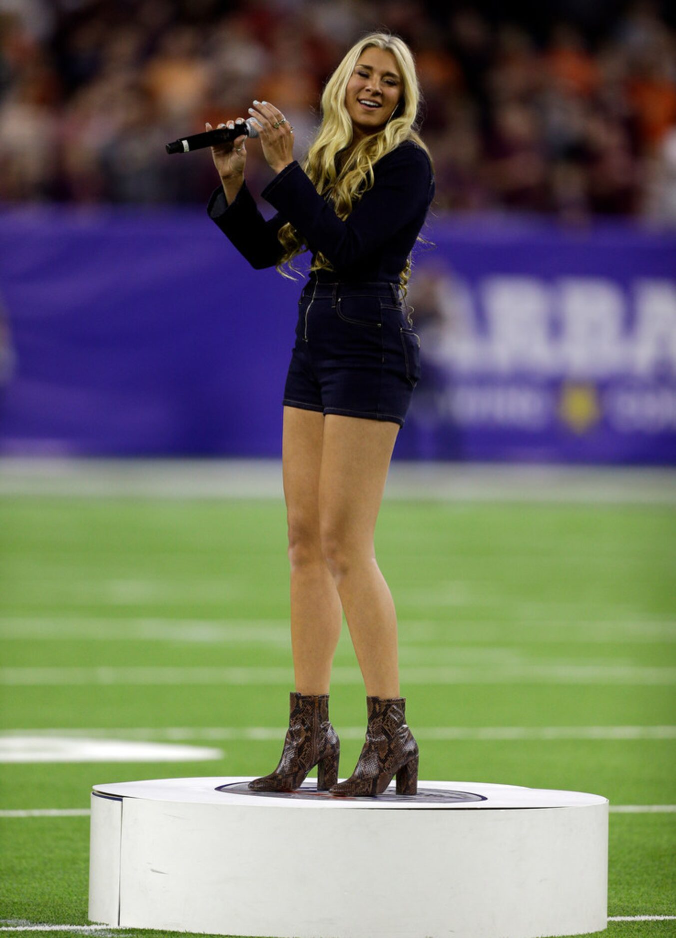 HOUSTON, TEXAS - DECEMBER 27: CMT's NEXT Artist Julia Cole sings the national anthem during...