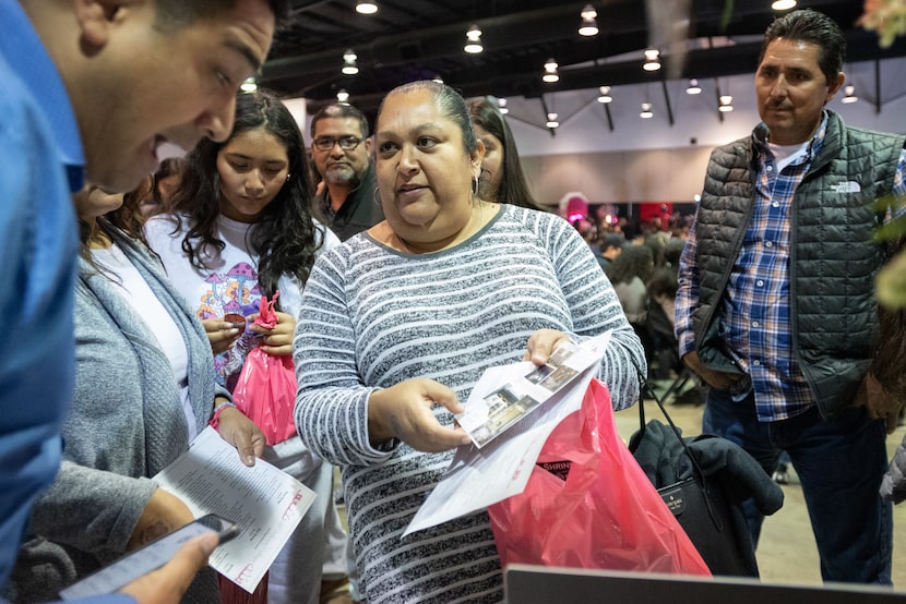 Mary Rios (center), and her husband Juan Rios, speak to Jose Bracamontes, (far left), as the...