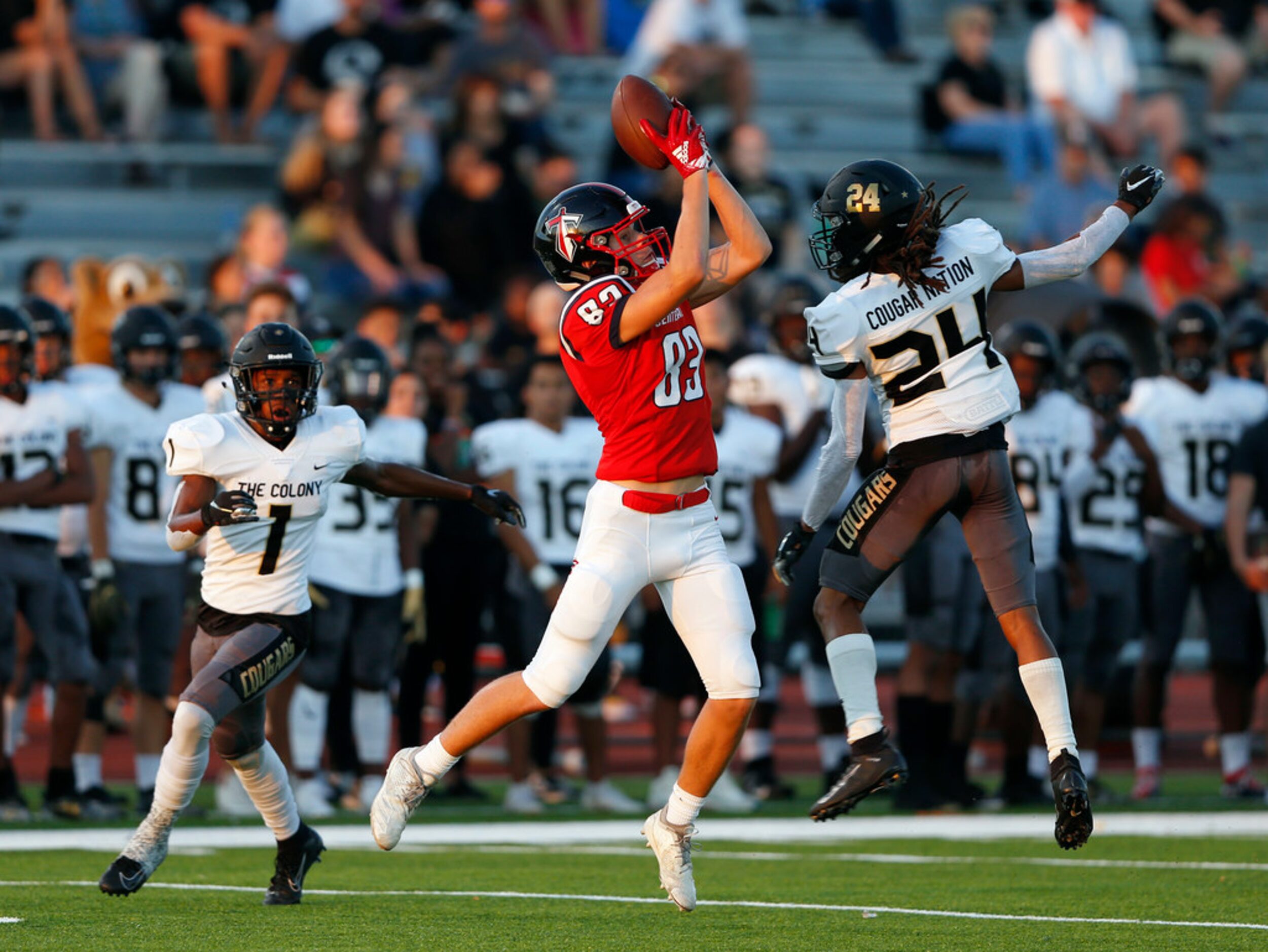 Centennial's Jacob McCoy (83) catches a pass in between The Colony's Myles Price (1) and...