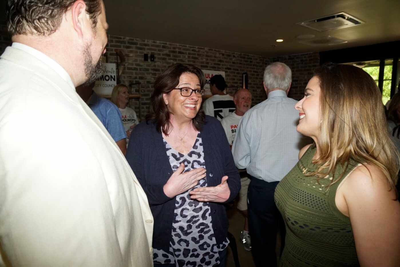 Paula Blackmon, center, talks with John Botefuhr, left, and Anne Maurer, right, during her...