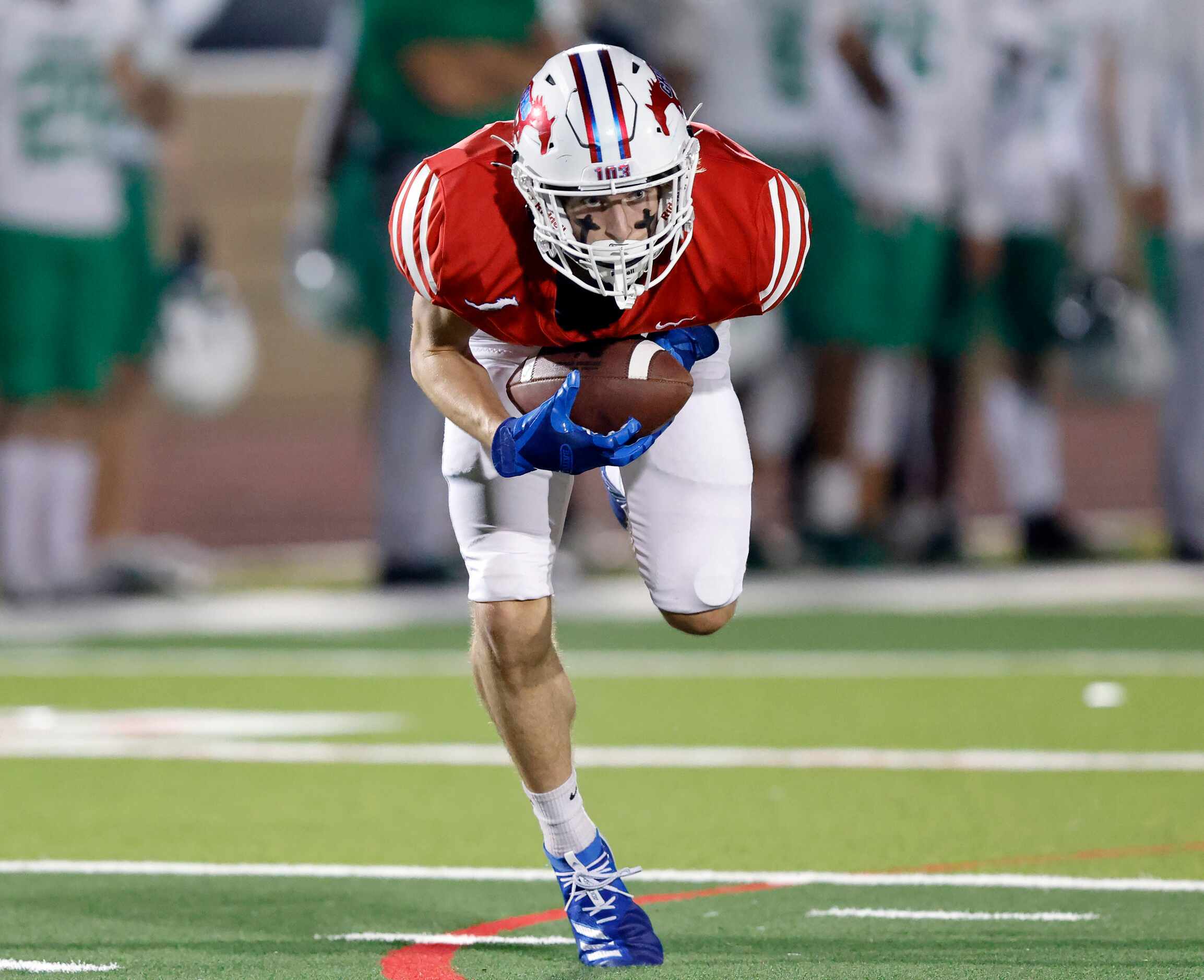 Grapevine receiver Kaden Cook (7) catches a pass across the middle against Lake Dallas...
