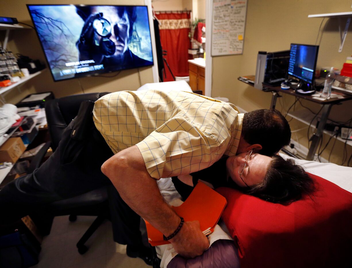 Heather Powell gets a hug from her counselor, Russell Gainer, after a weekly session at...