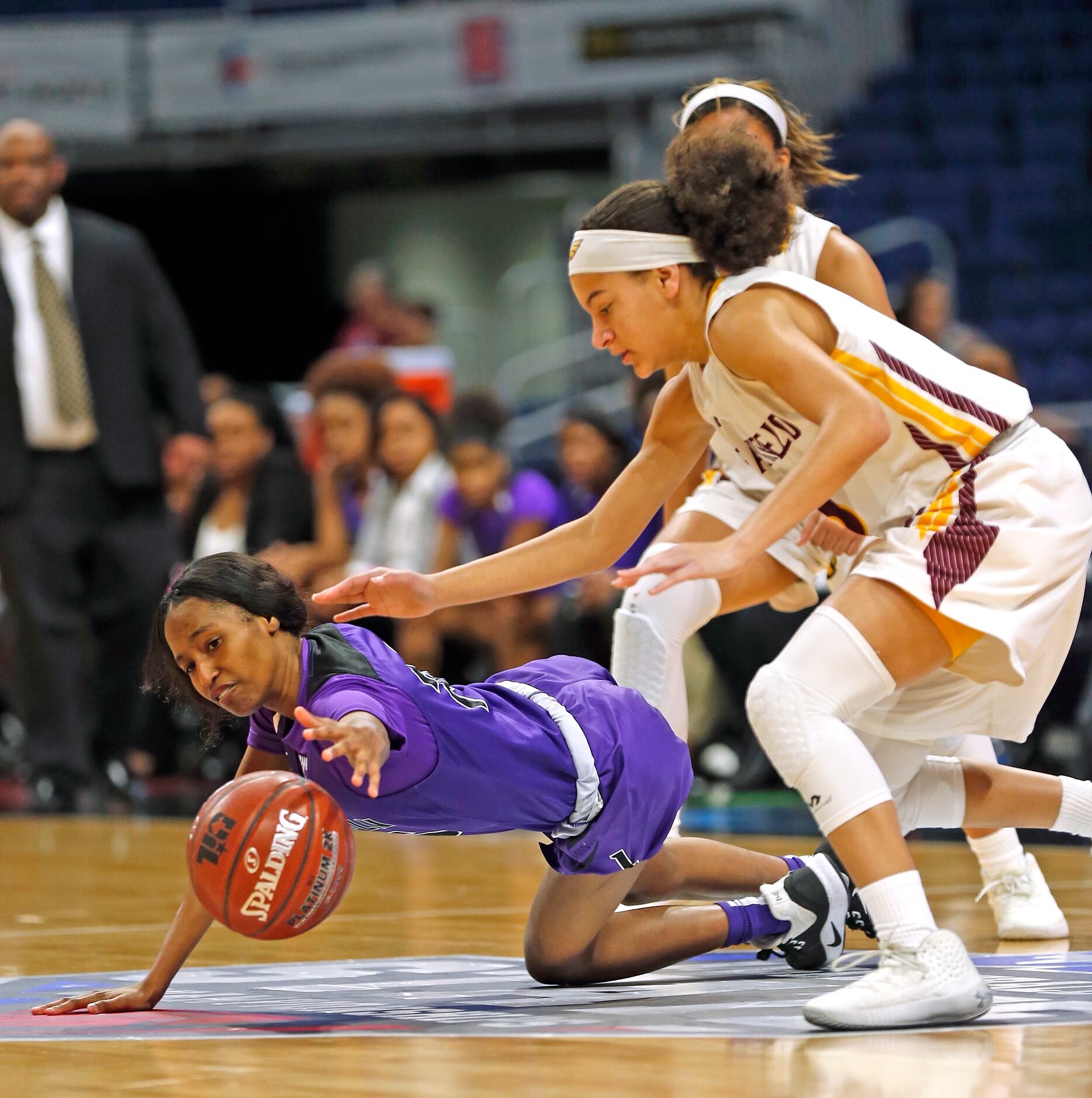 Lincoln center Heaven Johnson (#25) dives for a loose ball as Fairfield guard Jarahle...