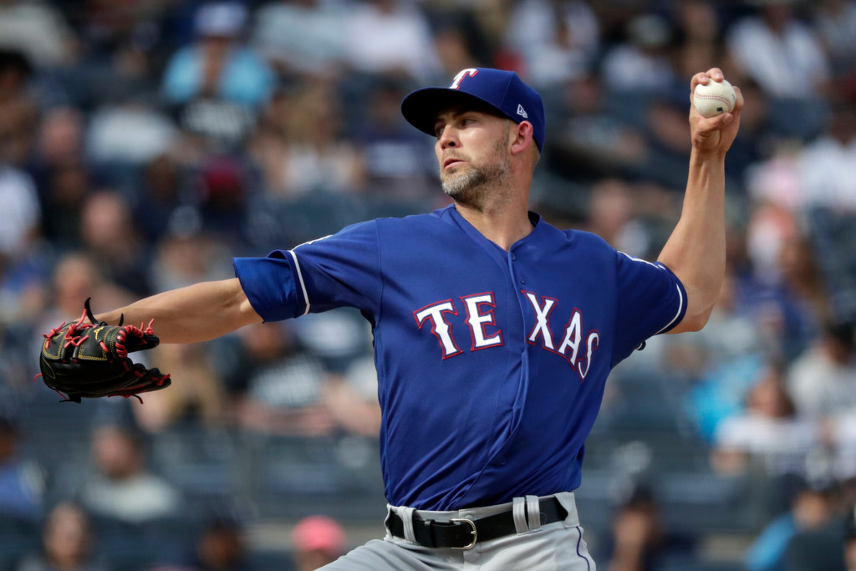 Texas Rangers pitcher Mike Minor delivers during the first inning of a baseball game against...