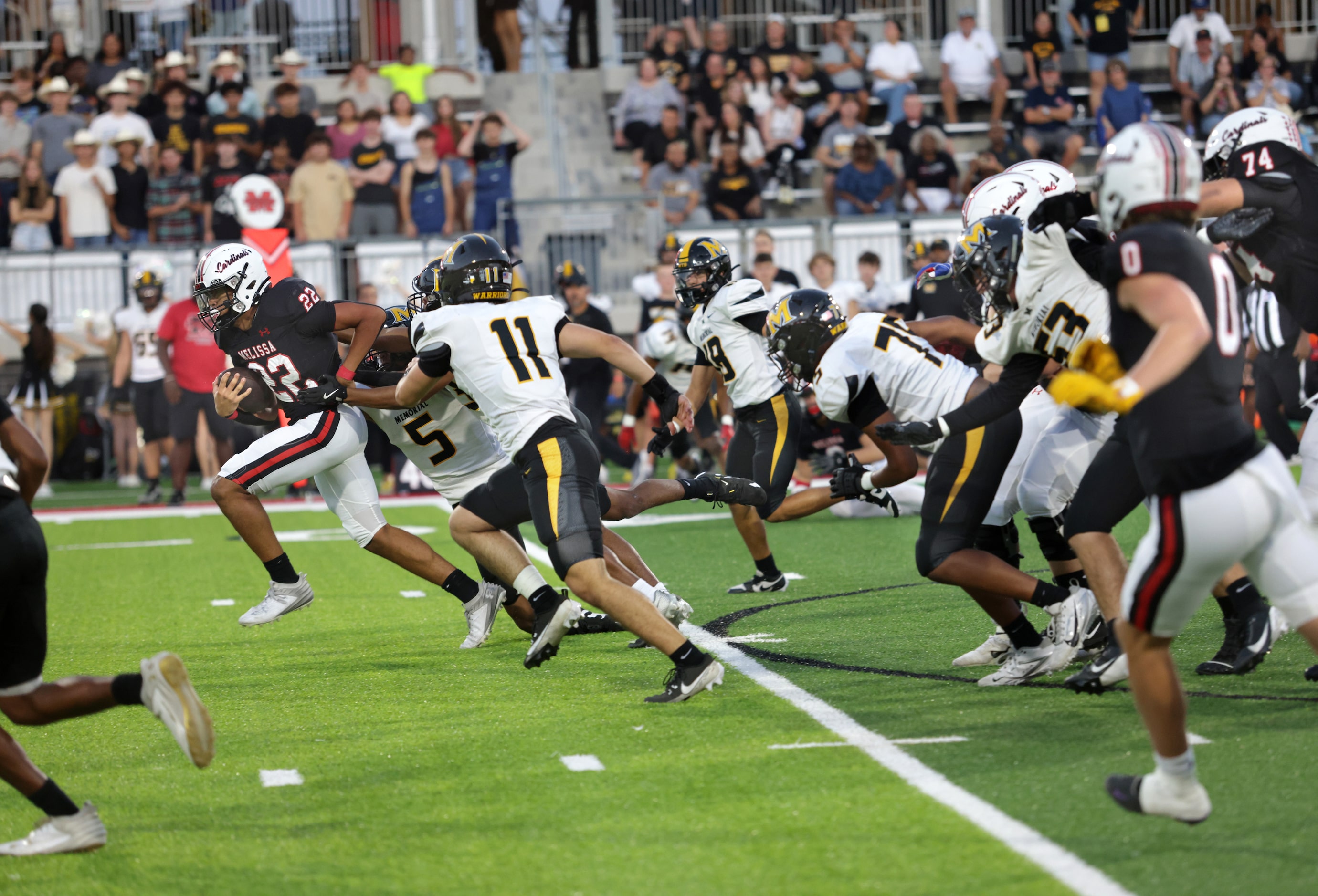 Melissa player #22 Jeremiah Tabor breaks away from some Memorial players during the Frisco...