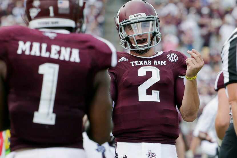 Texas A&M's Johnny Manziel (2) celebrates a touchdown with teammate Ben Malena (1) during...
