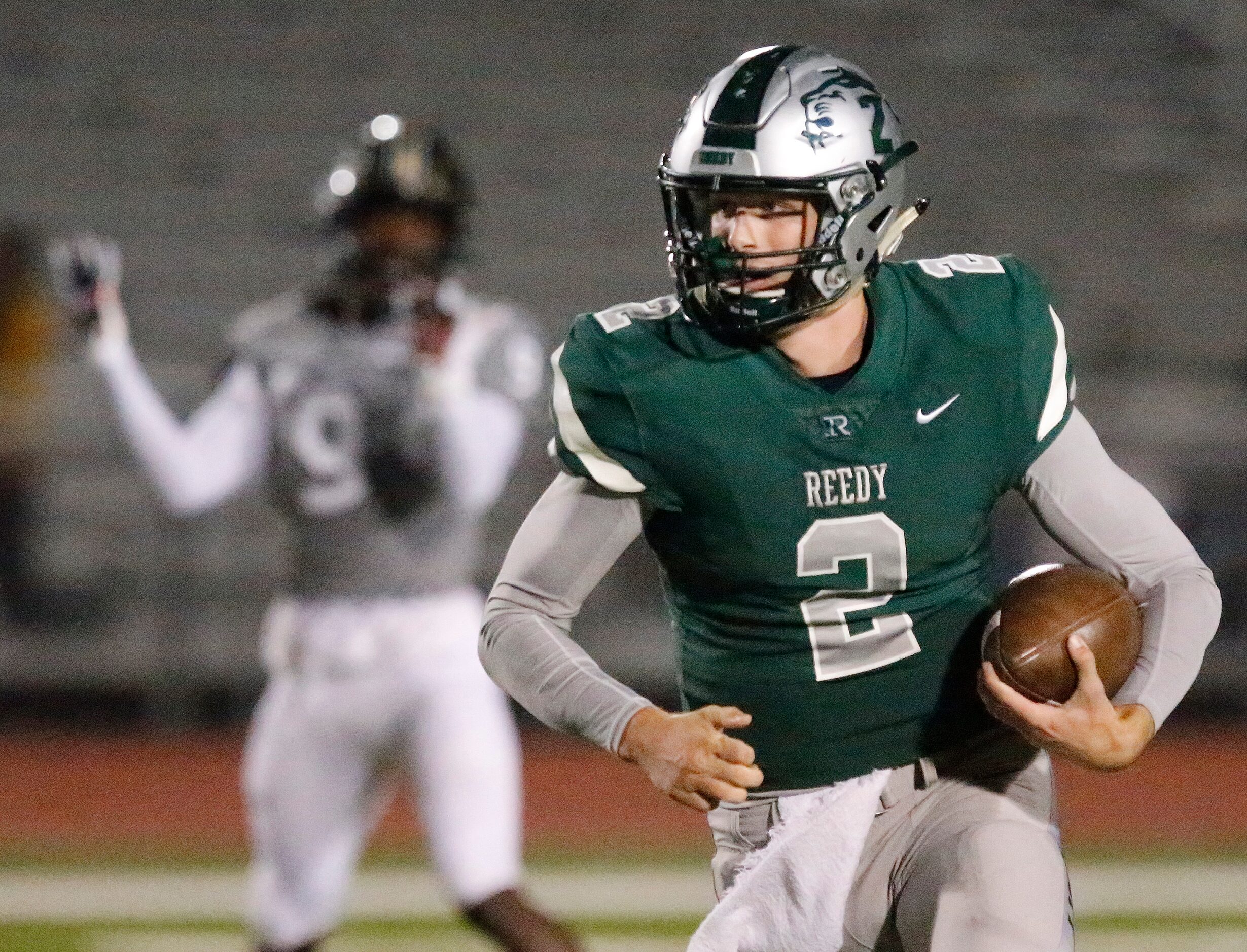 Frisco Reedy High School quarterback A.J. Padgett (2) keeps the ball during the first half...