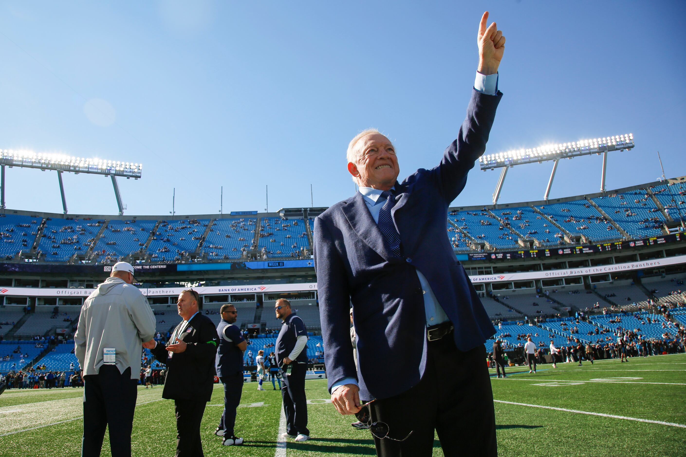 Dallas Cowboys owner Jerry Jones waves to fans during pregame workouts before an NFL game...