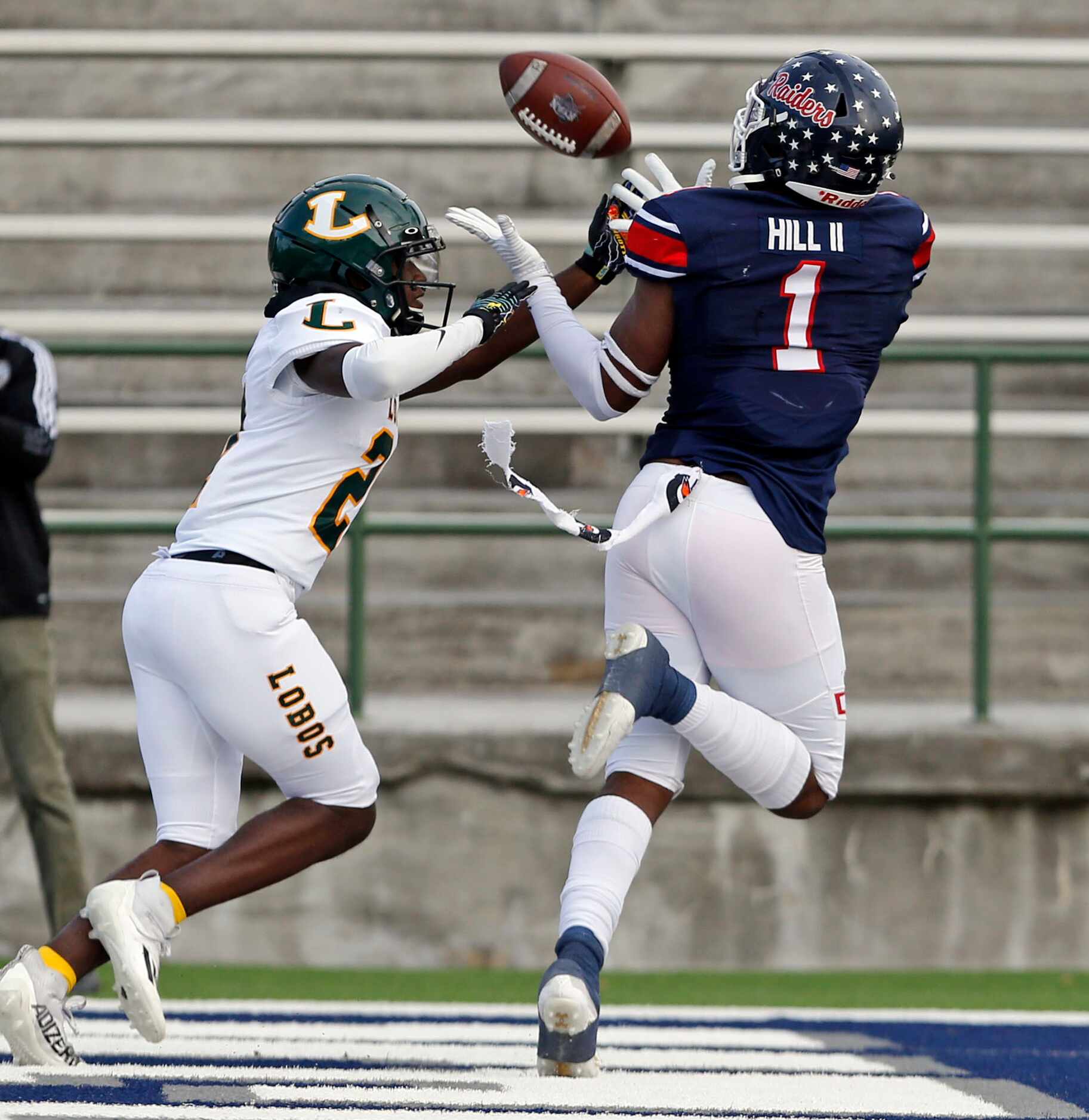 Denton Ryan’s MarQuice Hill II (1) gathers in a touchdown pass over Longview defender Chase...