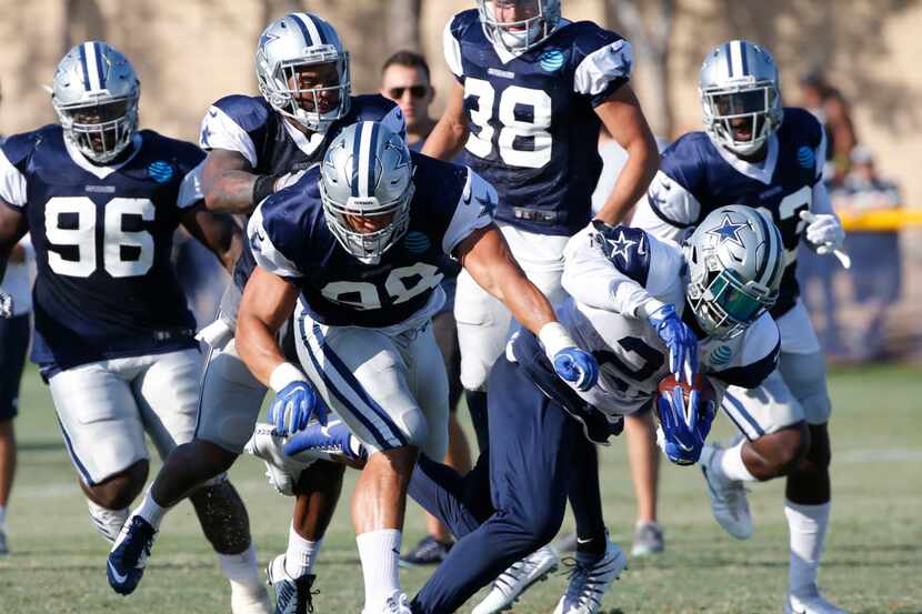 Dallas Cowboys defensive end Tyrone Crawford (98) gets tangled up with Dallas Cowboys...