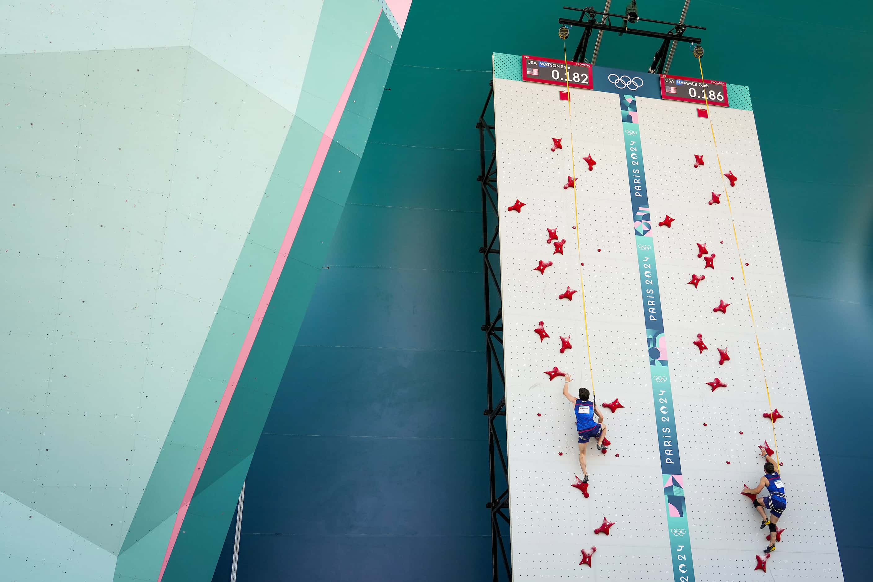 Sam Watson of the United States (left) climbs against teammate Zach Hammer in men’s speed...