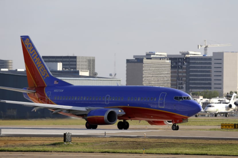 A Southwest Airlines jet is shown taking off from Love Field Wednesday, April 24, 2013, in...